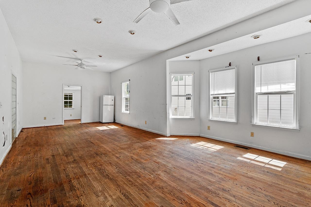 24 Dixie Trail Raleigh, NC 27607 - Photo 5 of 38 a view of empty room with wooden floor and fan