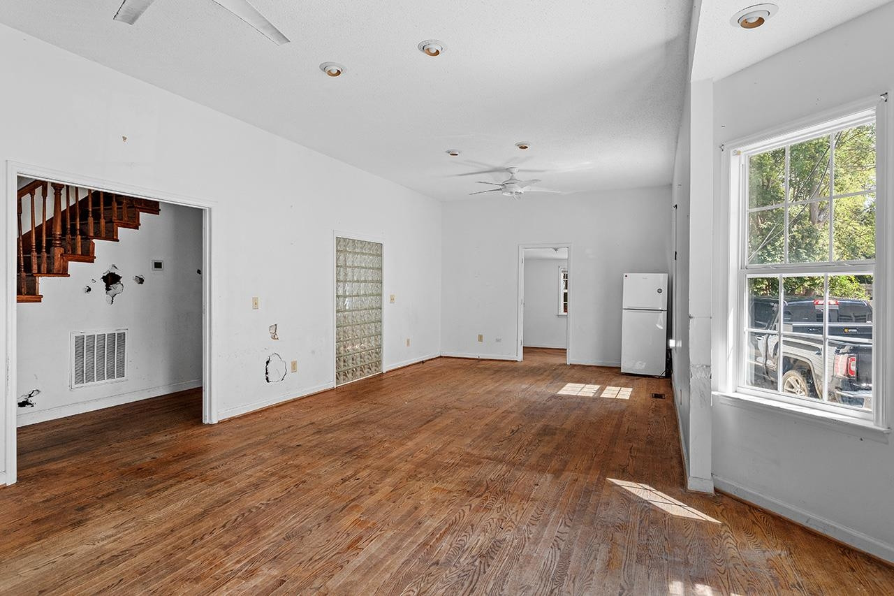 24 Dixie Trail Raleigh, NC 27607 - Photo 6 of 38 a view of an empty room with window and wooden floor