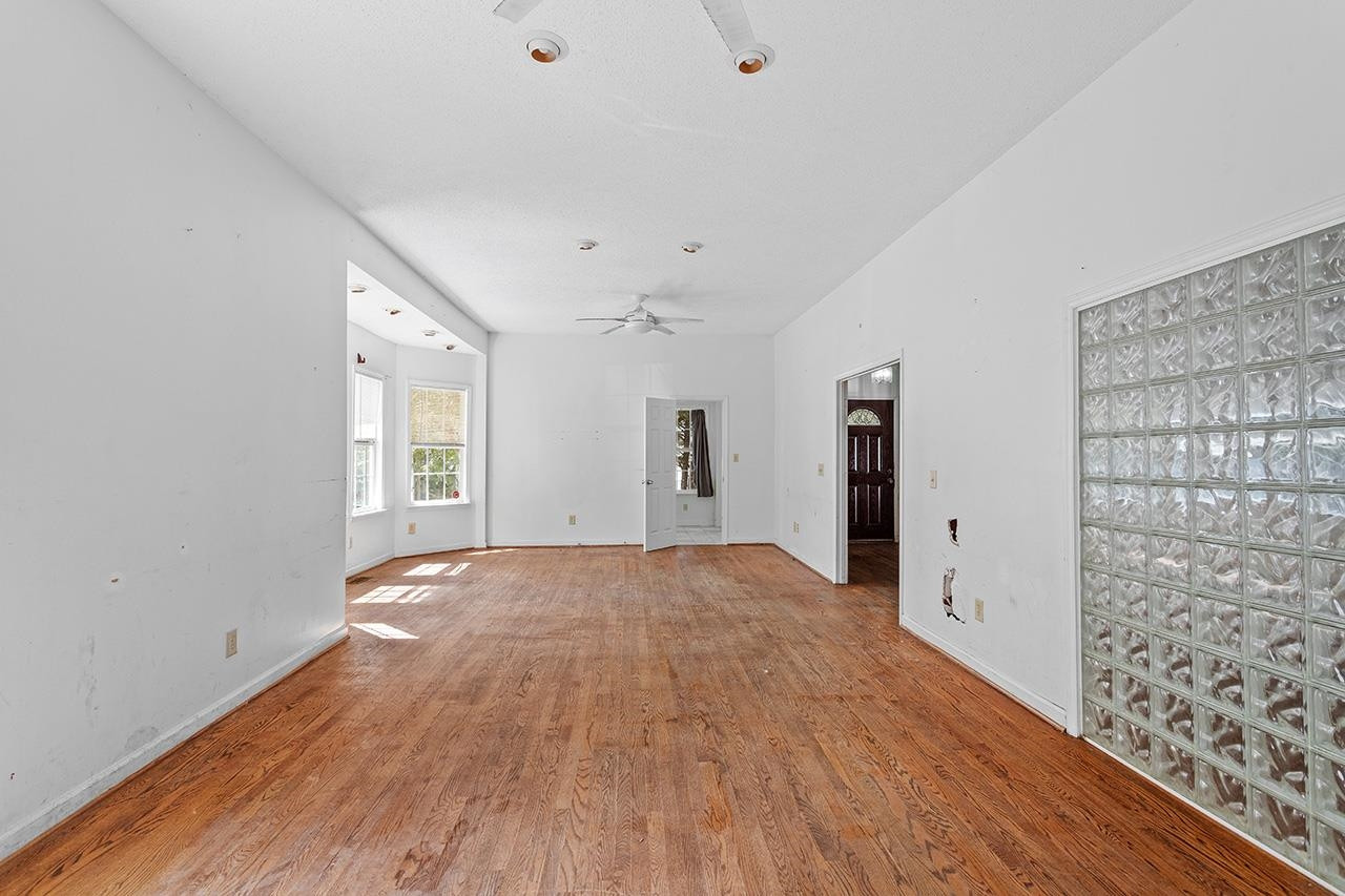24 Dixie Trail Raleigh, NC 27607 - Photo 7 of 38 a view of empty room with wooden floor and fan