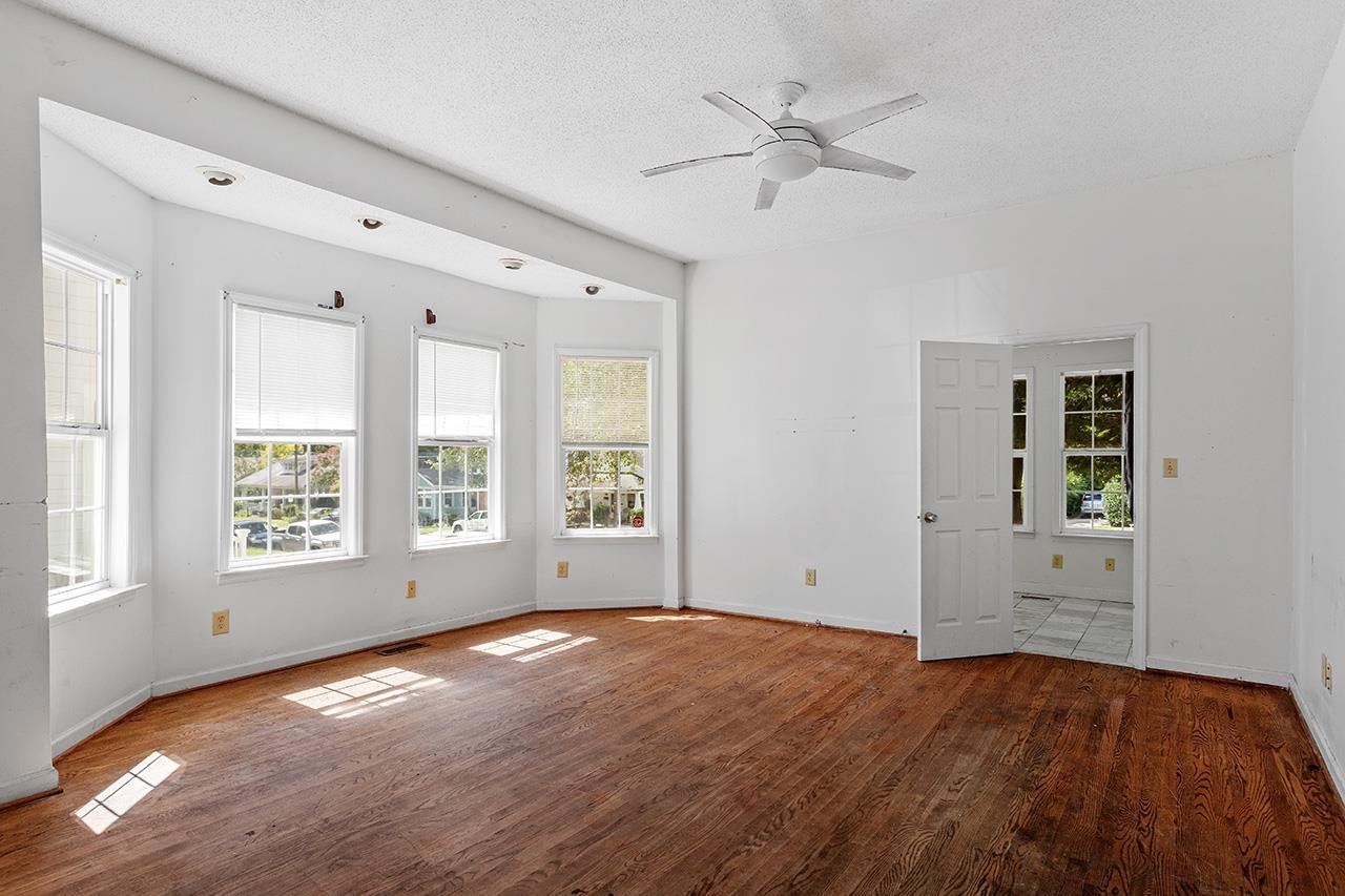 24 Dixie Trail Raleigh, NC 27607 - Photo 8 of 38 a view of empty room with wooden floor and fan