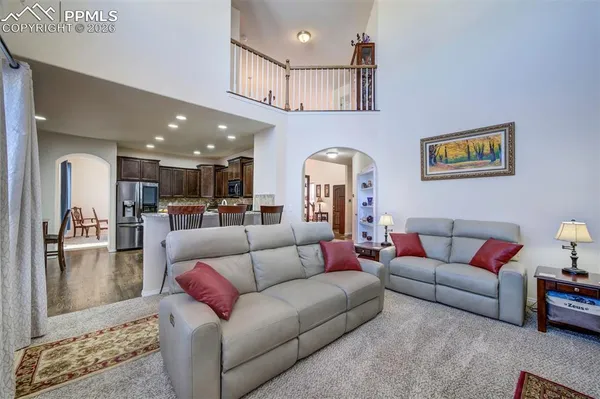 a living room with furniture and kitchen view