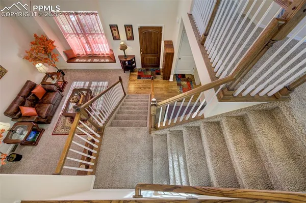 a view of stairs and hall with wooden floor