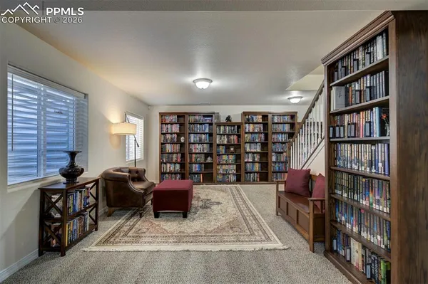 a living room with furniture a book shelf and a book shelf