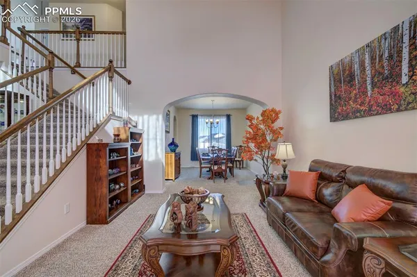 a living room with lots of furniture and wooden floor