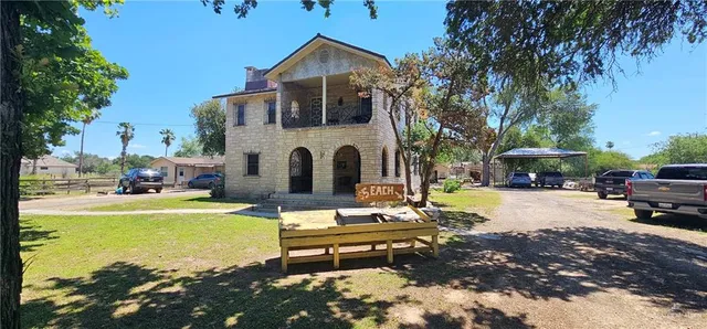a view of a house with swimming pool and sitting area