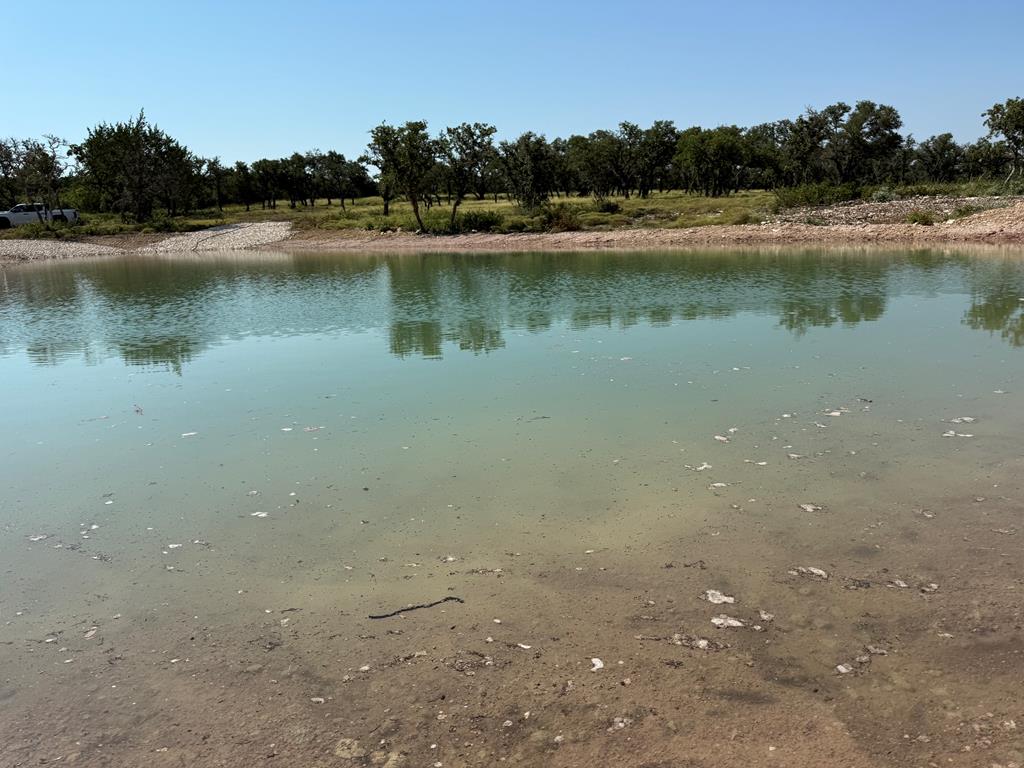 an aerial view of a house with a yard and lake view