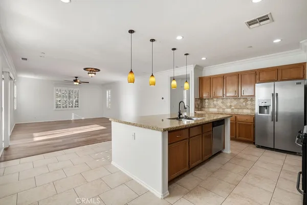 a kitchen with granite countertop a cabinets and steel stainless steel appliances