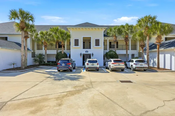 a view of a hallway with wooden floor and closet