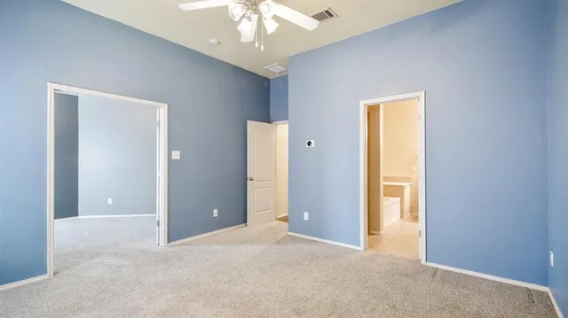 a view of a livingroom with a chandelier fan and closet area