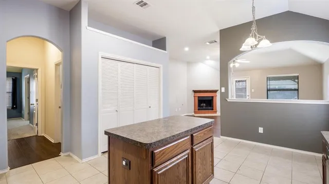 a view of kitchen with a sink and a fireplace