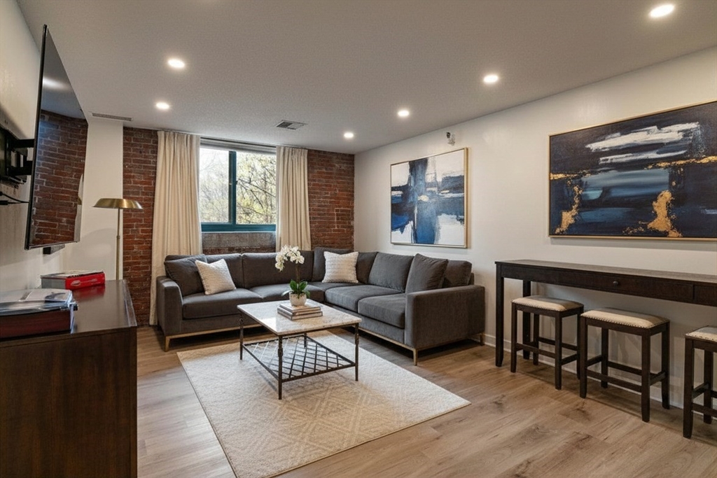42 8th Street, Unit 2308 Boston, MA 02129 - Photo 1 of 19 a living room with furniture and a flat screen tv