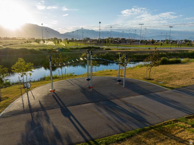 82 Provo River Road, Unit 251 Saratoga Springs, UT 84045 - Photo 31 of 32 Recreational park area featuring a walking path, fitness equipment, and a tranquil pond