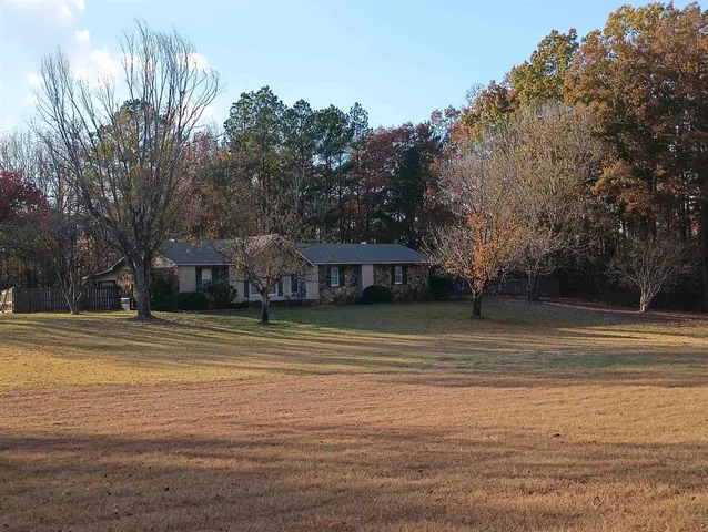 a view of a swimming pool with trees in the background