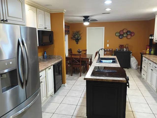 a kitchen with stainless steel appliances a stove a refrigerator and a sink