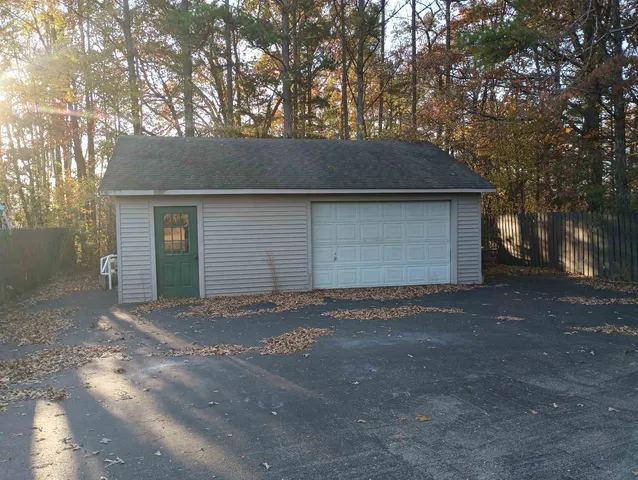 a backyard of a house with large trees and a yard
