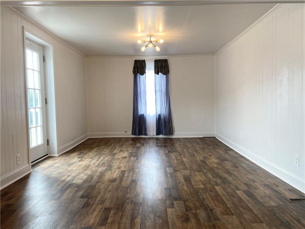 4319 Rte 908 Natrona Heights, PA 15065 - Photo 16 of 24 an empty room with wooden floor chandelier and windows