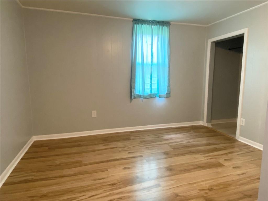 4319 Rte 908 Natrona Heights, PA 15065 - Photo 10 of 24 a view of an empty room with wooden floor and a window