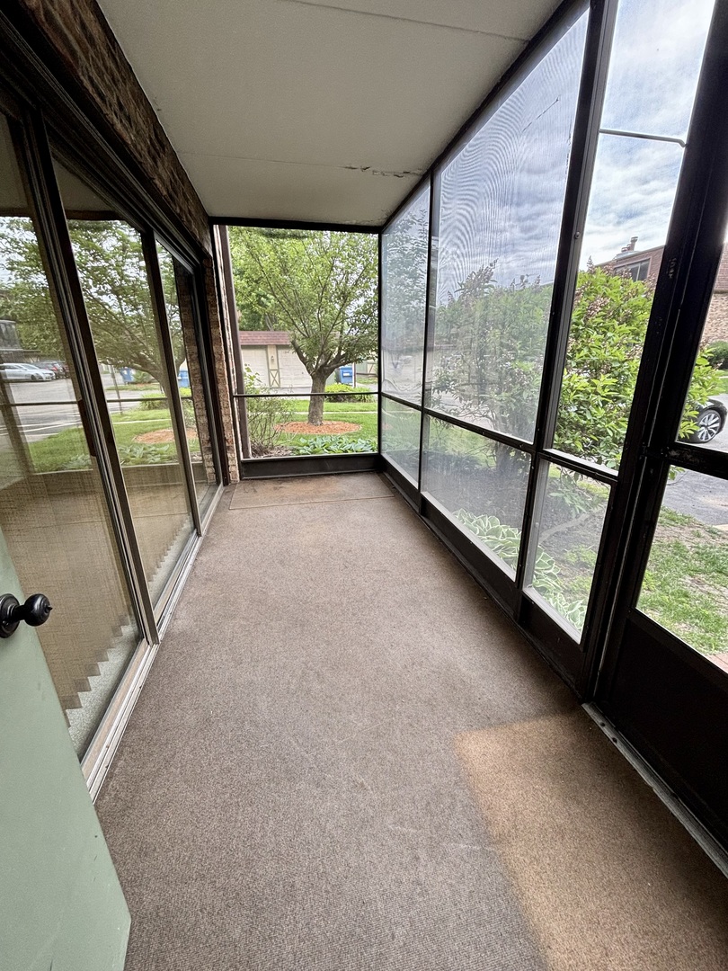 9168 S Road, Unit A Palos Hills, IL 60465 - Photo 12 of 14 a view of an empty room with a floor to ceiling window