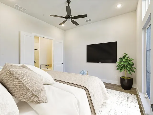 a bedroom with a bed and a flat screen tv