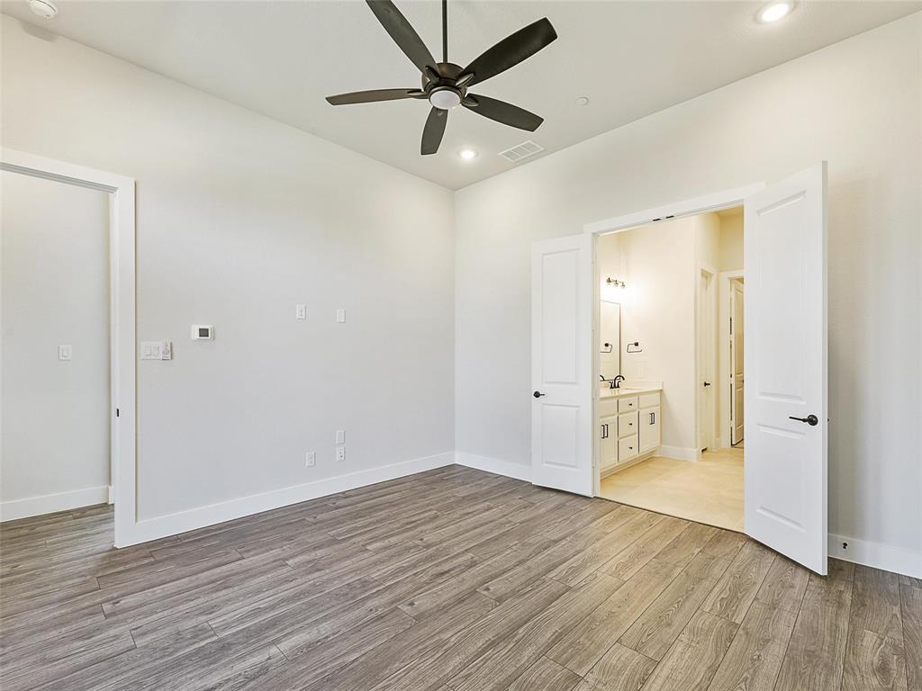 4299 Reeder Rdg Way Frisco, TX 75033 - Photo 16 of 30 an empty room with wooden floor and a ceiling fan