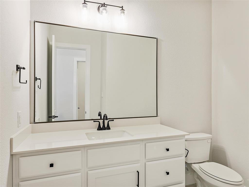 4299 Reeder Rdg Way Frisco, TX 75033 - Photo 25 of 30 a bathroom with a sink a toilet and mirror