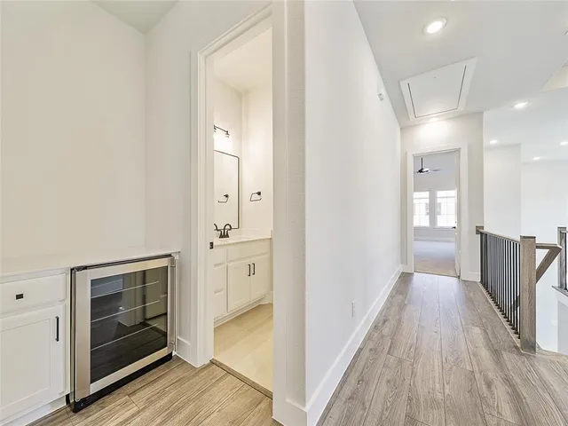 a view of a hallway with wooden floor and a fireplace