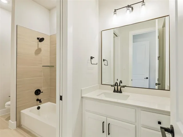 a bathroom with a bathtub and a sink