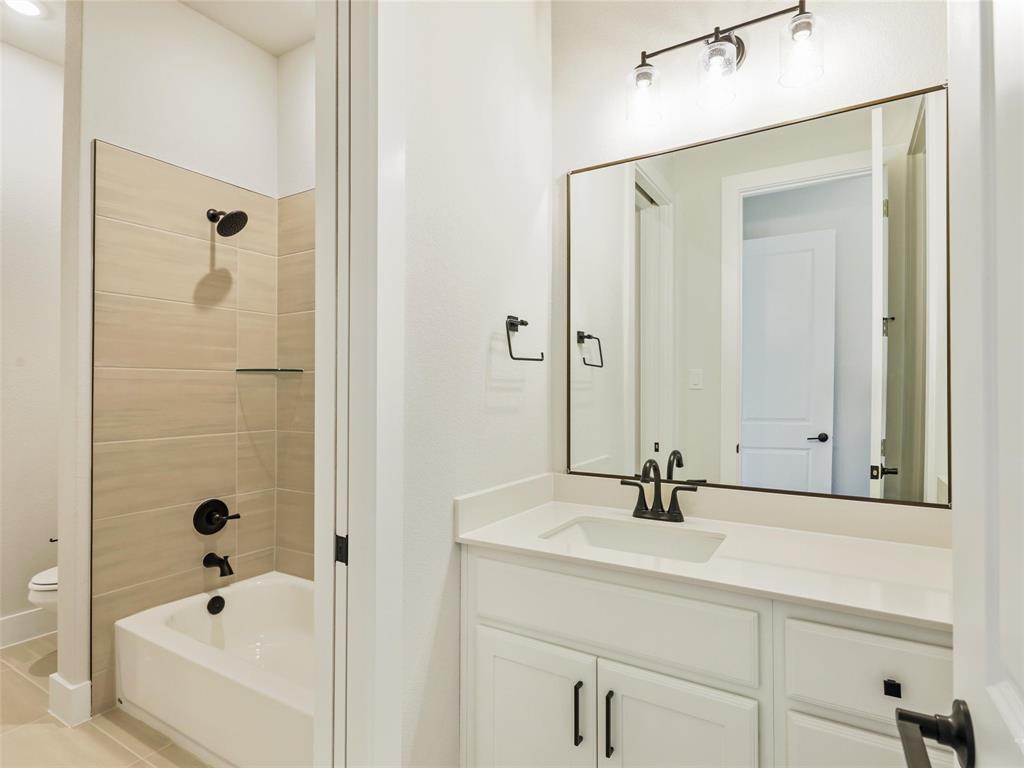 4299 Reeder Rdg Way Frisco, TX 75033 - Photo 28 of 30 a bathroom with a bathtub and a sink