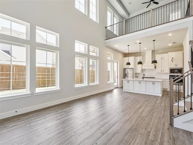 a view of large kitchen with wooden floor and windows