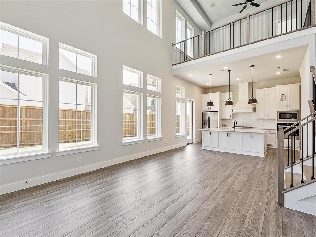 4299 Reeder Rdg Way Frisco, TX 75033 - Photo 10 of 30 a view of large kitchen with wooden floor and windows