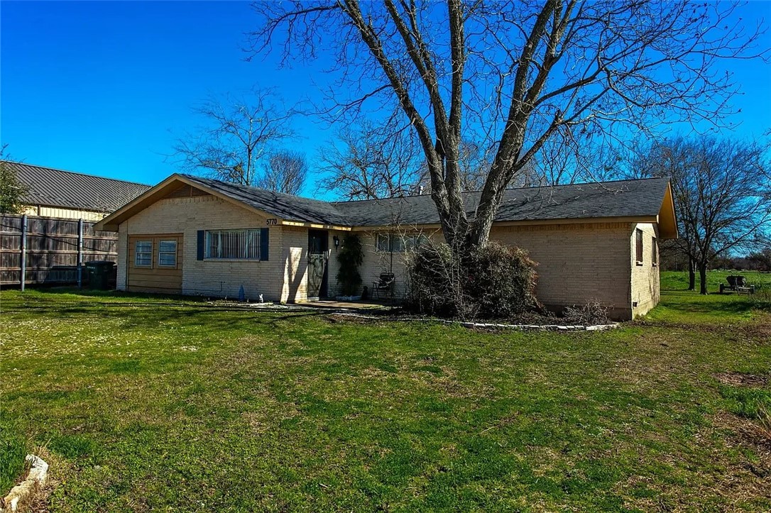 5770 East State Highway 21 Bryan, TX 77808 - Photo 1 of 9 a front view of a house with a garden