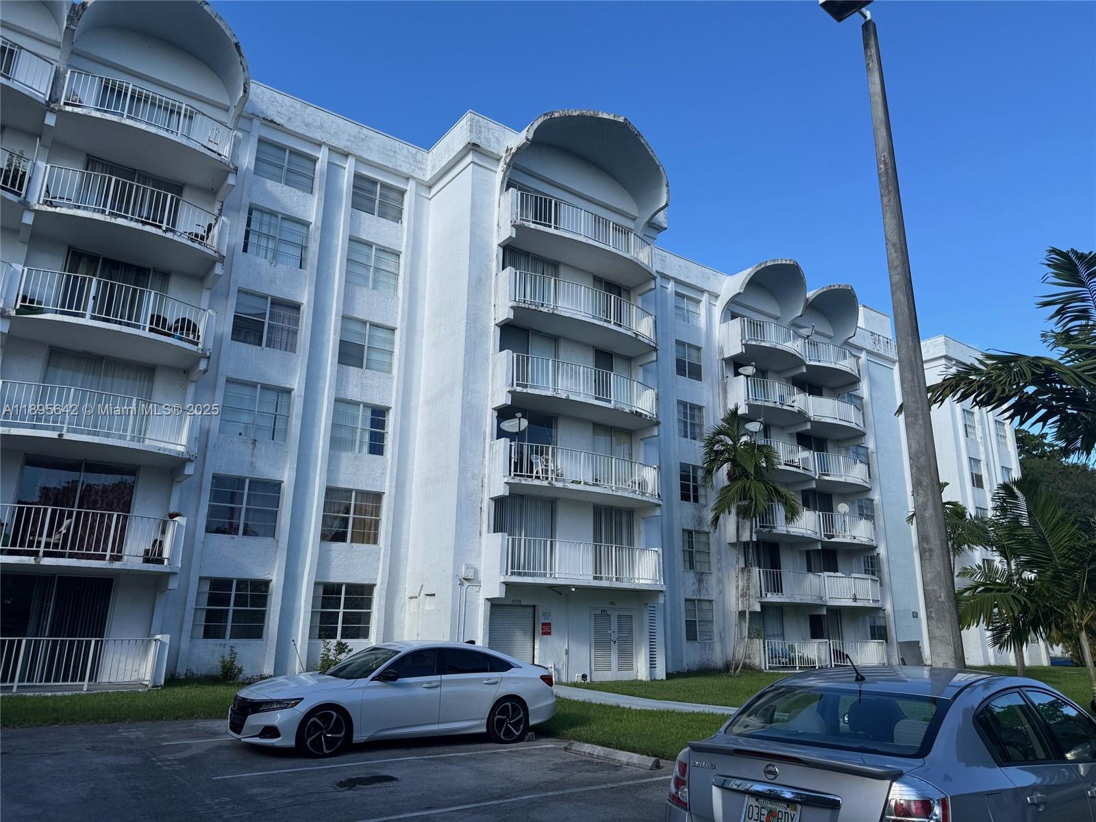 a car parked in front of a brick building