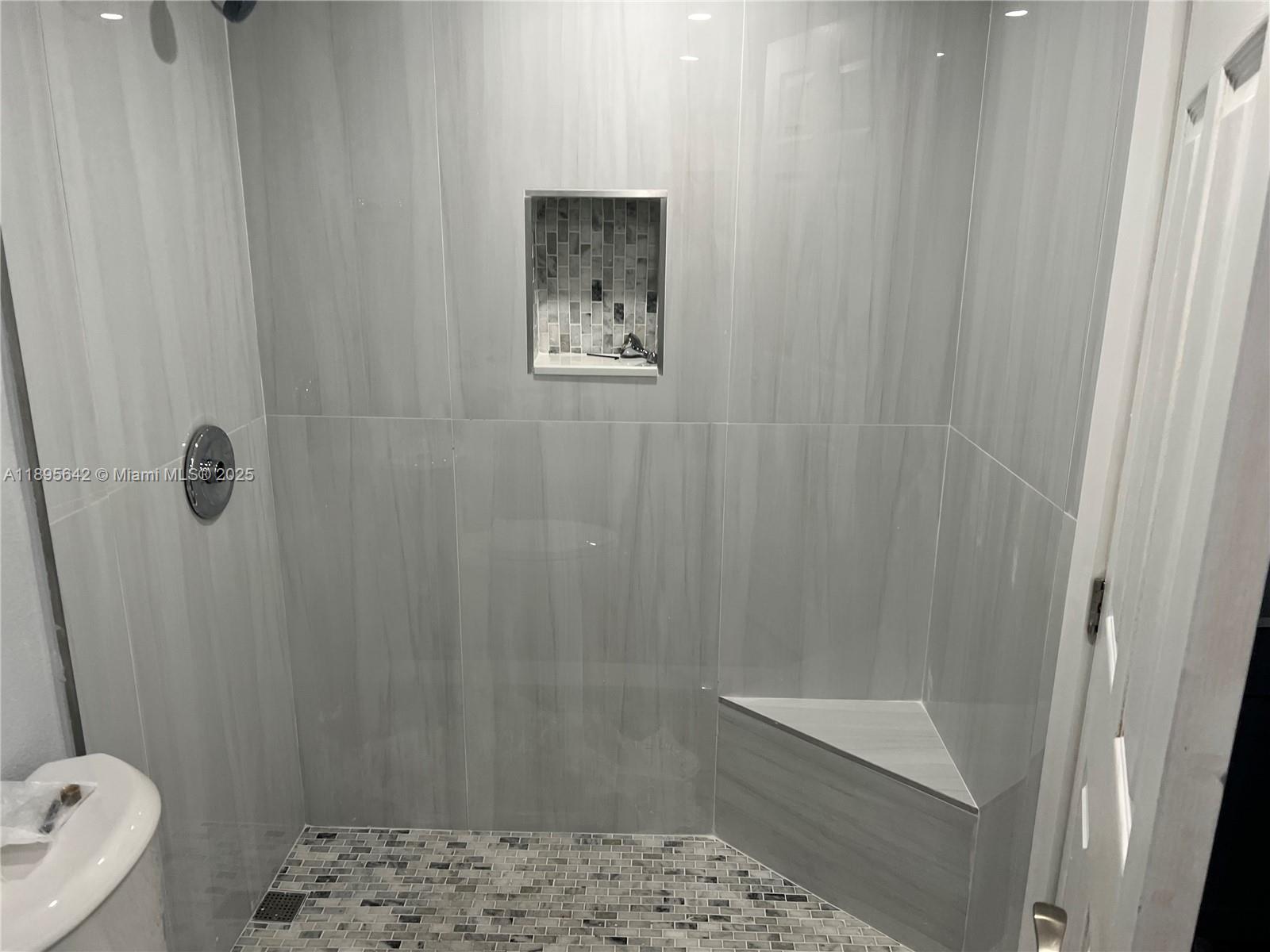 494 Northwest 165th Street, Unit C207 Miami, FL 33169 - Photo 4 of 14 a bathroom with a shower