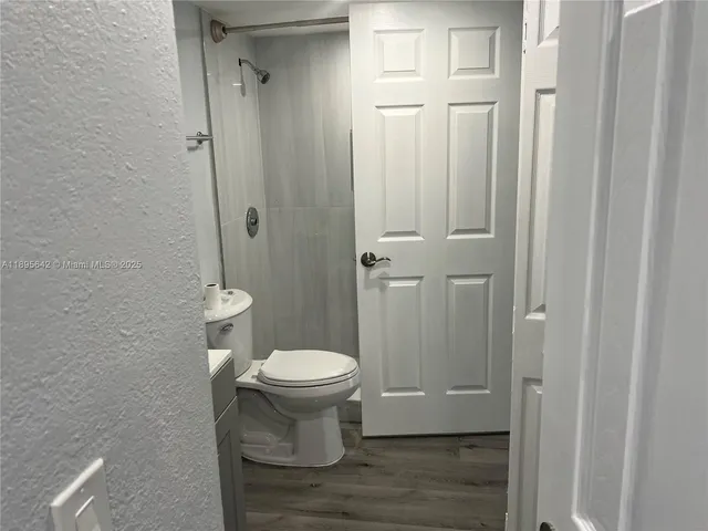 a white toilet sitting next to a bathroom sink