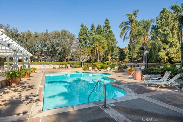 a view of a swimming pool with an outdoor space and seating area