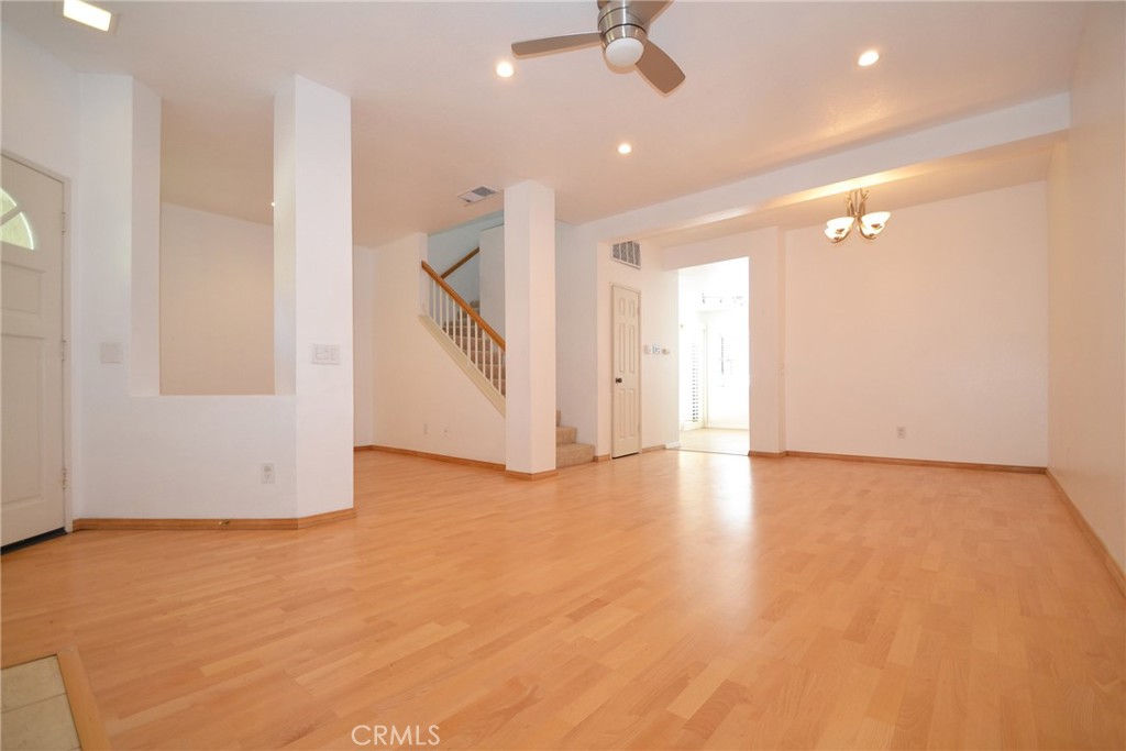 2615 Plaza Del Amo, Unit 636 Torrance, CA 90503 - Photo 4 of 22 an empty room with wooden floor fan and windows