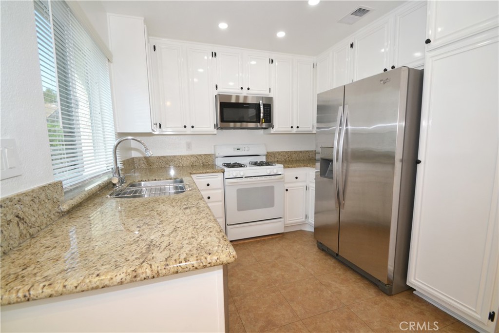 2615 Plaza Del Amo, Unit 636 Torrance, CA 90503 - Photo 7 of 22 a kitchen with stainless steel appliances granite countertop a refrigerator a stove a sink and a microwave