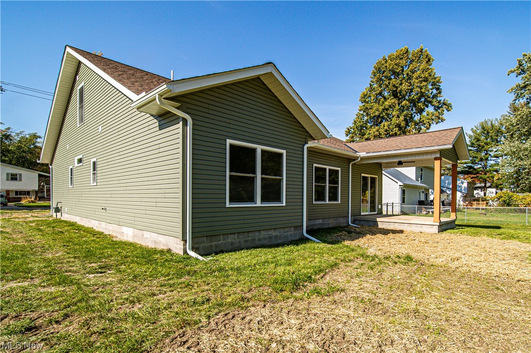 1745 Green Road Madison, OH 44057 - Photo 6 of 35 Back of house with a patio area and a lawn