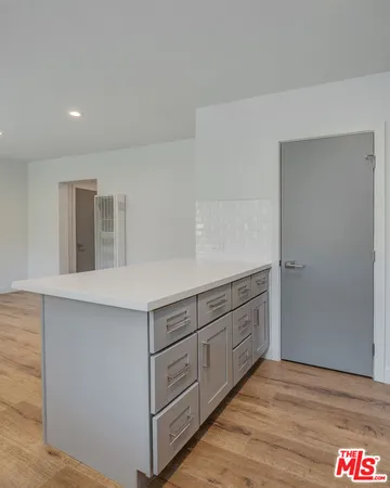 a room with cabinets and wooden floor