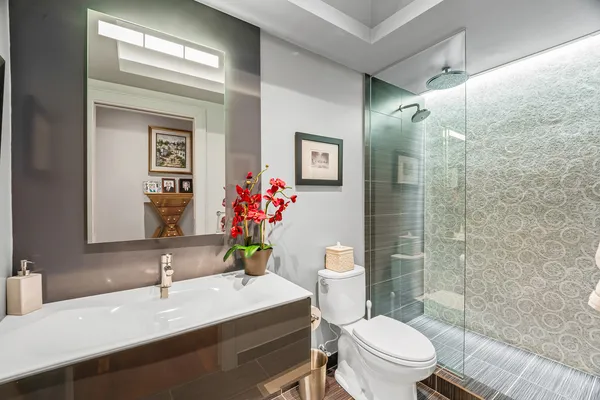 a bathroom with a sink mirror and toilet