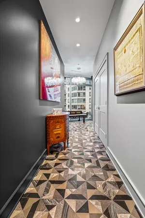 a living room with furniture a rug and a floor to ceiling window