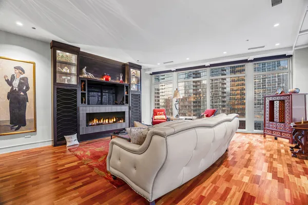 a living room with furniture a flat screen tv and a kitchen view