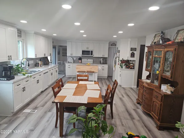 a kitchen with a table and chairs in it