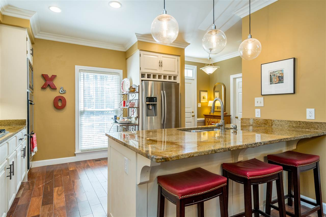 717 Weathergreen Drive Raleigh, NC 27615 - Photo 11 of 30 Stainless steel appliances, beautiful wood flooring, white cabinets, granite counters, gas cook top, plus more! Renovated kitchen!