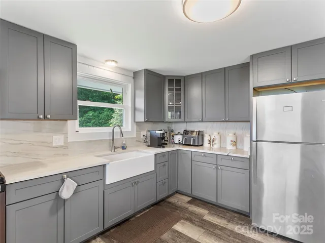 a view of a dining room with furniture a livingroom and chandelier