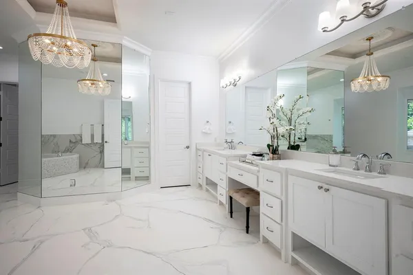 a spacious bathroom with a double vanity sink mirror and a bath tub