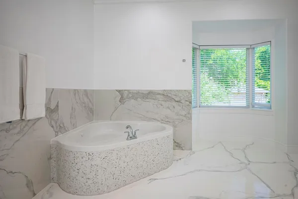 a bathroom with a bathtub and window