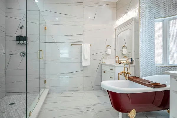 a bedroom with a bed lamp and a potted plant