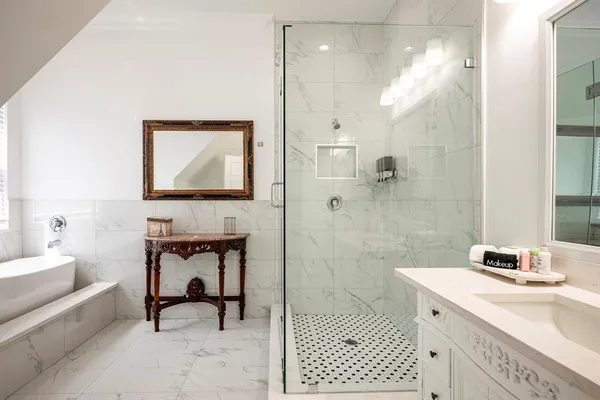 a spacious bedroom with a bed and a chandelier