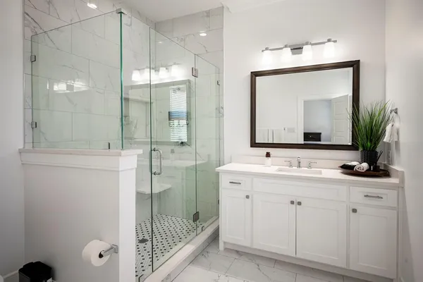 a bathroom with a sink a toilet and shower